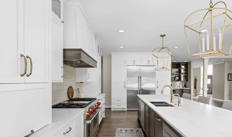 Spacious kitchen with gold pendants